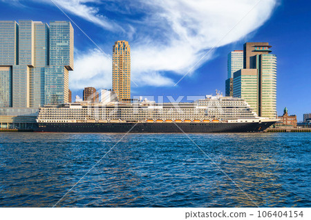 Big cruise ship parked in center of rotterdam. View of the skyscrapers of rotterdam on a sunny day 106404154