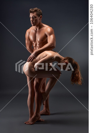 Naked fit couple doing kamasutra poses in the middle of studio Naked fit couple doing kamasutra poses in the middle of studio 106404280