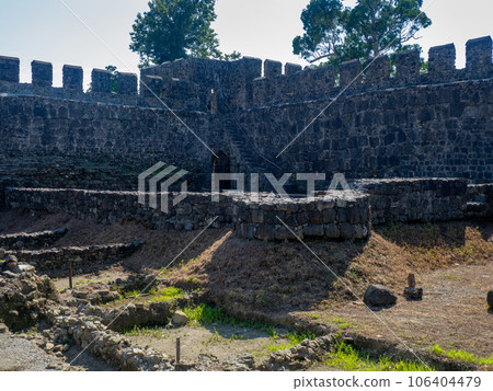 Loopholes. Battle tower. Castle defense.  Archeology.  Ruins of an ancient castle. At the archaeological site. Ruined Palace Museum. Fortress Gonio. The architecture of antiquity. 106404479