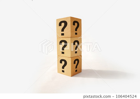Stack of three wooden cubes with question mark over nature background with sunlight with copy space 106404524