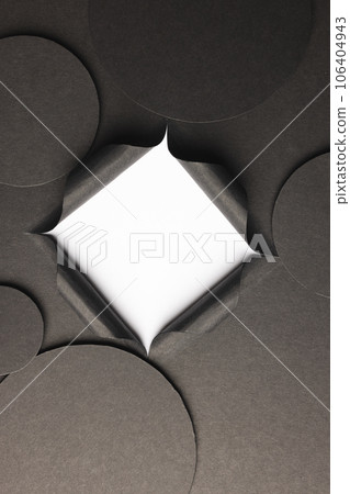 Vertical image of circles of black paper with copy space and square opening on white background Vertical image of circles of black paper with copy space and square opening on white background 106404943