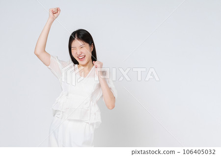 Young asian woman with raised hands celebrating success isolated on white background. 106405032
