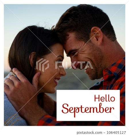 Composite of hello september text over caucasian couple on beach 106405127