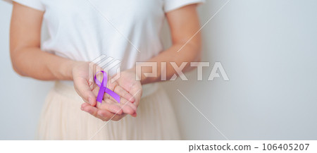 Woman holding purple Ribbon for Violence, Pancreatic, Esophageal, Testicular cancer, Alzheimer, epilepsy, lupus, Sarcoidosis and Fibromyalgia. Awareness month and World cancer day concept 106405207
