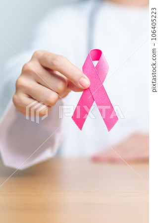 Pink October Breast Cancer Awareness month, woman doctor with pink Ribbon in hospital for support people life and illness. National cancer survivors month, Mother and World cancer day concept Pink October Breast Cancer Awareness month, woman doctor with pink Ribbon in hospital for support people life and illness. National cancer survivors month, Mother and World cancer day concept 106405223