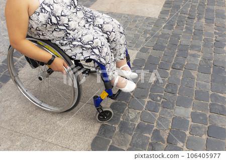 Cropped Adult With Short Stature On Wheelchair Stands On Bus Stop in Street, Outdoor Waiting For Public Transport At Summer Day. Unrecognizable Female Adult With Disability. Transportation. Horizontal 106405977