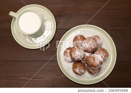 Top View Thursday Carnival or Tlusty Czwartek, Polish Christian tradition. Zeppole Or Paczki On Plate With Powdered Sugar, Cup Of Milk On Wooden Table. Doughnut, Delicious Donuts. Horizontal Plane Top View Thursday Carnival or Tlusty Czwartek, Polish Christian tradition. Zeppole Or Paczki On Plate With Powdered Sugar, Cup Of Milk On Wooden Table. Doughnut, Delicious Donuts. Horizontal Plane 106405999