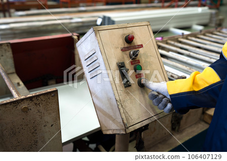 A tireless worker, diligently operates an intricate contraption within a bustling factory. A tireless worker, diligently operates an intricate contraption within a bustling factory. 106407129