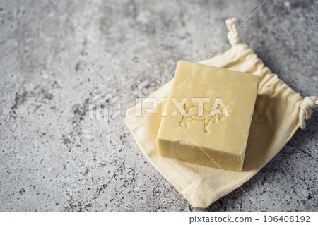 Goat Soap with cotton fabric, soap, over gray background. Zero waste, natural organic bathroom tools. Plastic free life. Ecological skin care, body treatment concept. 106408192