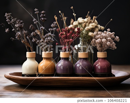A collection of fall scent aroma diffusers on a wooden tray. A collection of fall scent aroma diffusers on a wooden tray. 106408221