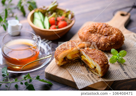 Bread Freshly baked homemade curry bread (with soft-boiled eggs) served with salad and tea 106408471