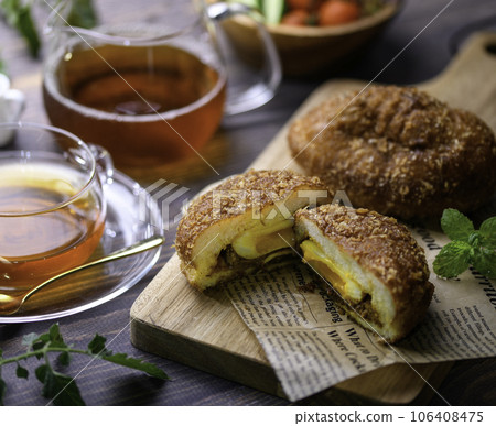 Bread Freshly baked homemade curry bread (with soft-boiled eggs) served with salad and tea Bread Freshly baked homemade curry bread (with soft-boiled eggs) served with salad and tea 106408475