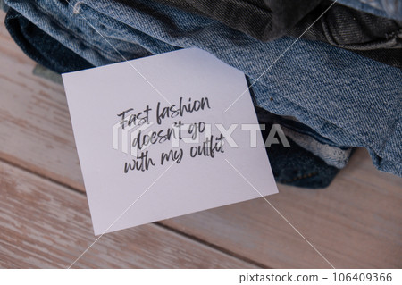 FAST FASHION DOESNT GO WITH MY OUTFIT text on paper note on Jeans clothes assortment Second hand sustainable shopping. Capsule minimal wardrobe. Sustainable fashion overconsumption, conscious buying FAST FASHION DOESNT GO WITH MY OUTFIT text on paper note on Jeans clothes assortment Second hand sustainable shopping. Capsule minimal wardrobe. Sustainable fashion overconsumption, conscious buying 106409366