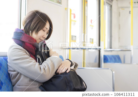 middle-aged woman sleeping on the train 106411311