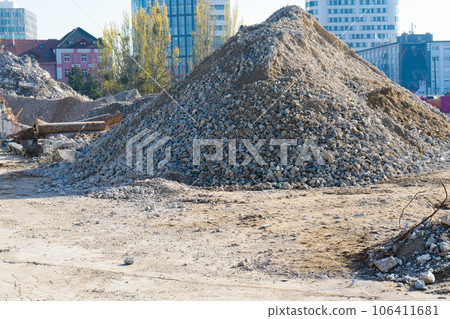 Large hills and piles of sand, gravel, crushed stone of white, gray and black color. Large hills and piles of sand, gravel, crushed stone of white, gray and black color. 106411681