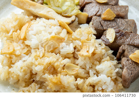 Garlic rice and a bite of steak. Garlic rice and a bite of steak. 106411730