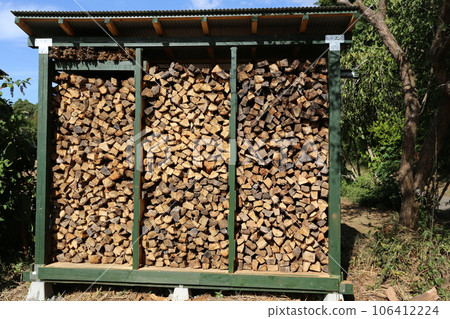 Firewood dried and stored in the firewood shelf Firewood dried and stored in the firewood shelf 106412224