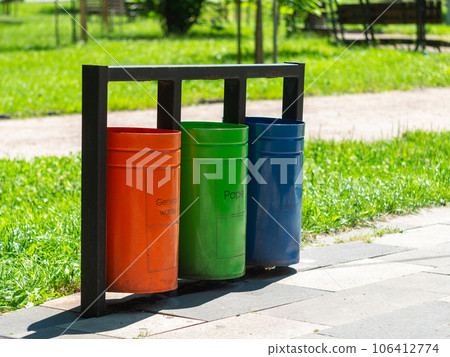 Colorful metal recycle trash bins for paper, glass, plastic and general waste public park urban area Garbage sorting Colorful metal recycle trash bins for paper, glass, plastic and general waste public park urban area Garbage sorting 106412774