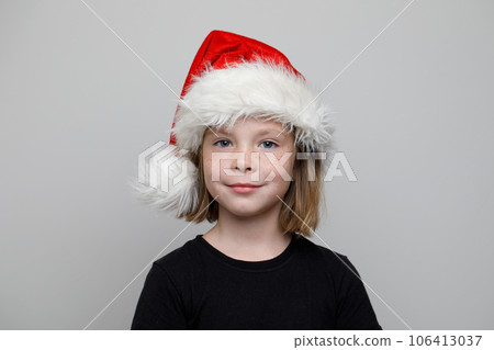 Christmas portrait of cute child girl in Santa hat smiling on white background 106413037