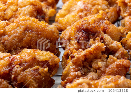Freshly fried chicken thighs on a frying pan. Freshly fried chicken thighs on a frying pan. 106413518