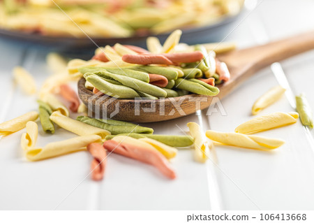 Fusilli pugliesi. Italian twisted pasta on wooden spoon. 106413668