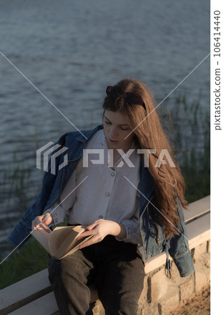 Portrait of a beautiful girl with a book. 106414440