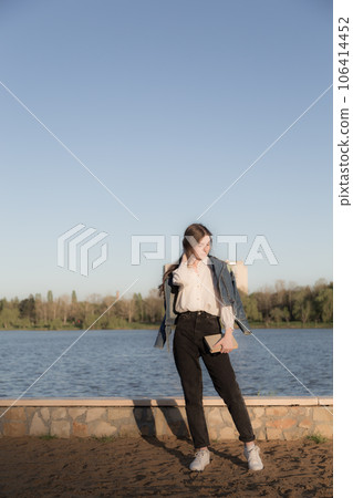 Portrait of a beautiful girl with a book. 106414452