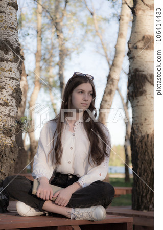Portrait of a beautiful girl with a book. 106414483