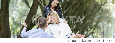 Disabled unhappy woman in wheelchair with friend Disabled unhappy woman in wheelchair with friend 106414858