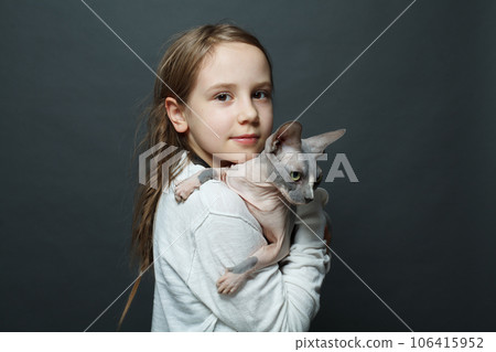 Beautiful happy child girl with cat on blue background 106415952