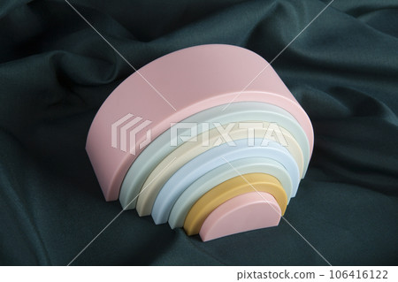 plastic rainbow toy on a green curtain 106416122