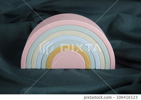 plastic rainbow toy on a green curtain 106416123