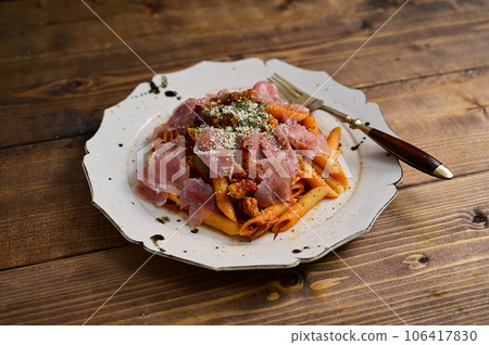 Penne with prosciutto and tomato sauce Penne with prosciutto and tomato sauce 106417830