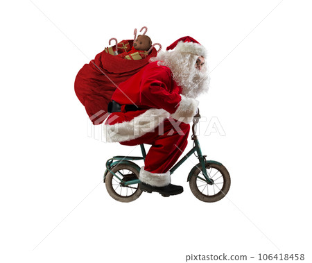 Santaclaus rides bike to deliver fast christmas gifts 106418458