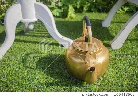 a tea kettle on a chair, used during the traditional bridal shower 106418603