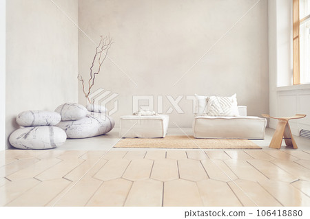 Minimalist interior with stones, sofa, dry branch and small table. Layout for your design, paintings, light interior design for your poster with copy space. Flooring and empty wall. High quality photo Minimalist interior with stones, sofa, dry branch and small table. Layout for your design, paintings, light interior design for your poster with copy space. Flooring and empty wall. High quality photo 106418880
