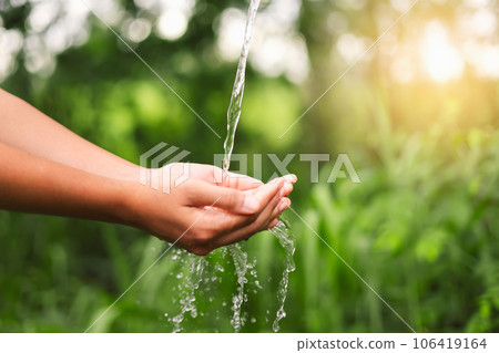 Water pouring on hand in morning ligth background 106419164