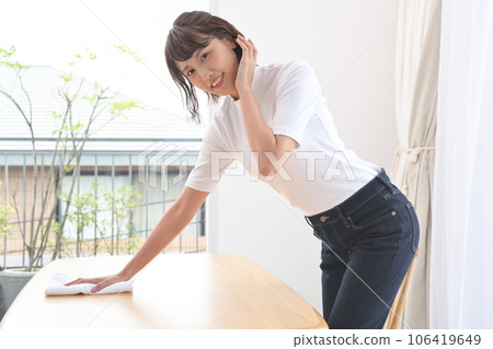 A woman wiping the table with a cloth A woman wiping the table with a cloth 106419649