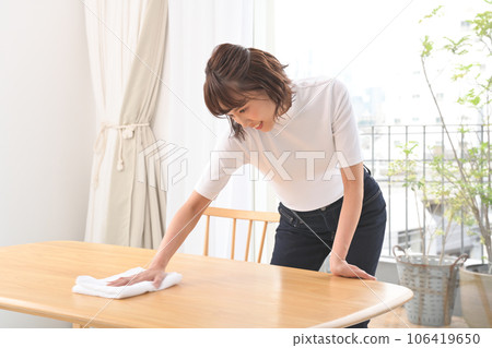 A woman wiping the table with a cloth A woman wiping the table with a cloth 106419650