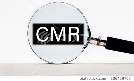 CMR Contract Management Review or Clear Motion Rate lettering on through a magnifying glass on a light background 106419703
