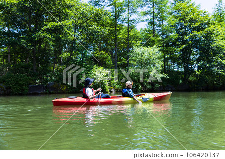 Parent and child enjoying kayaking Parent and child enjoying kayaking 106420137
