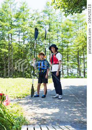 family enjoying kayaking 106420218