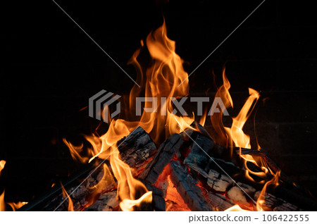 Close-up of a fire burning in a fireplace. Close-up of a fire burning in a fireplace. 106422555