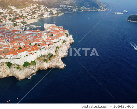 Aerial view of rooftops of Dubrovnik old historical town and Adriatic sea in Croatia. UNESCO World Heritage site, Famous tourist attraction. Vacation and adventure Aerial view of rooftops of Dubrovnik old historical town and Adriatic sea in Croatia. UNESCO World Heritage site, Famous tourist attraction. Vacation and adventure 106423406