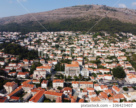 Aerial view of rooftops of Dubrovnik old historical town and Adriatic sea in Croatia. UNESCO World Heritage site, Famous tourist attraction. Vacation and adventure Aerial view of rooftops of Dubrovnik old historical town and Adriatic sea in Croatia. UNESCO World Heritage site, Famous tourist attraction. Vacation and adventure 106423407