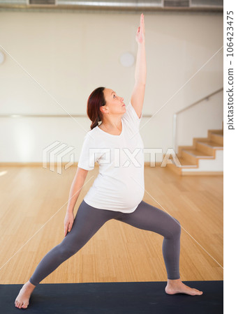 Pregnant woman does yoga in the gym Pregnant woman does yoga in the gym 106423475