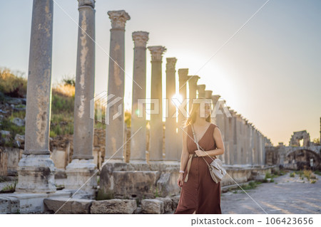 Pretty tourist woman at the ruins of ancient city of Perge near Antalya Turkey Pretty tourist woman at the ruins of ancient city of Perge near Antalya Turkey 106423656