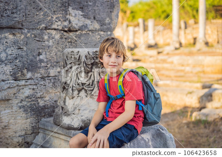 Boy tourist at the ruins of ancient city of Perge near Antalya Turkey. Traveling with kids concept Boy tourist at the ruins of ancient city of Perge near Antalya Turkey. Traveling with kids concept 106423658