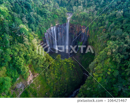 Aerial top view from above of Tumpak Sewu ,also known as Coban Sewu, 120m high waterfall in Malang regency, East Java, Indonesia 106425467