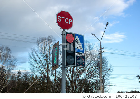 Red traffic light on background of trees and blue sky Red traffic light on background of trees and blue sky 106426108